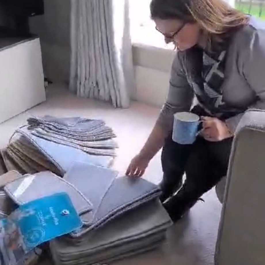 Woman picking carpet from samples